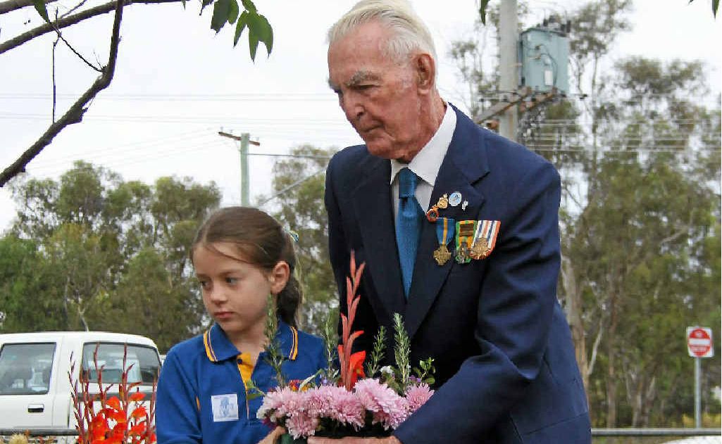 SOLEMN OCCASION: Ballandean State School student Allegra Daveson and veteran Wally Noordhoff lay a wreath during the school’s Anzac ceremony. SOLEMN OCCASION: Ballandean State School student Allegra Daveson and veteran Wally Noordhoff lay a wreath during the school’s Anzac ceremony.